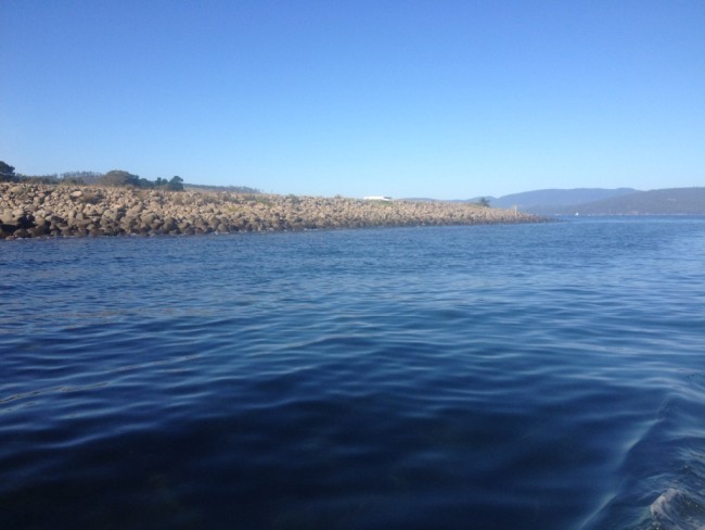 Dennes Point, looking south from the entrance to D’Entrecasteaux Channel. The dolerite boulders forming the spit curving away along the channel stand several metres above high water mark.